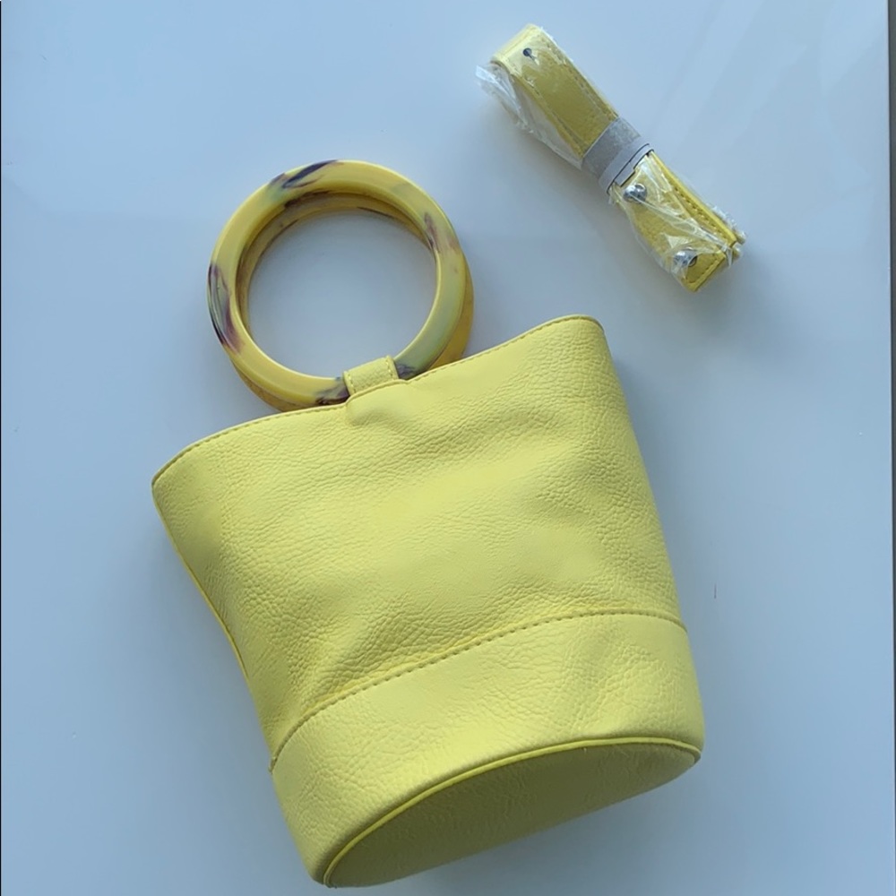 Yellow leather bucket bag with acrylic handle